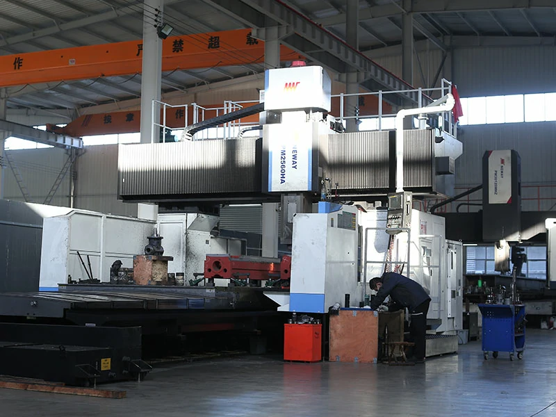 Overview of LS hydraulic press workshop showing gantry milling machine